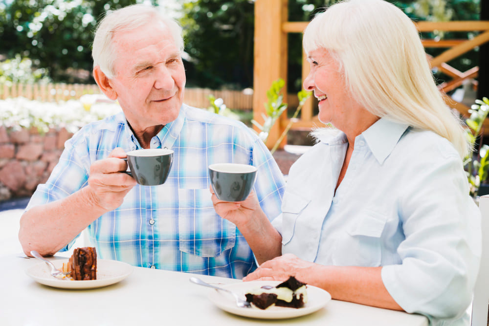 Smiling mature couple enjoying coffee together outdoors in Australia